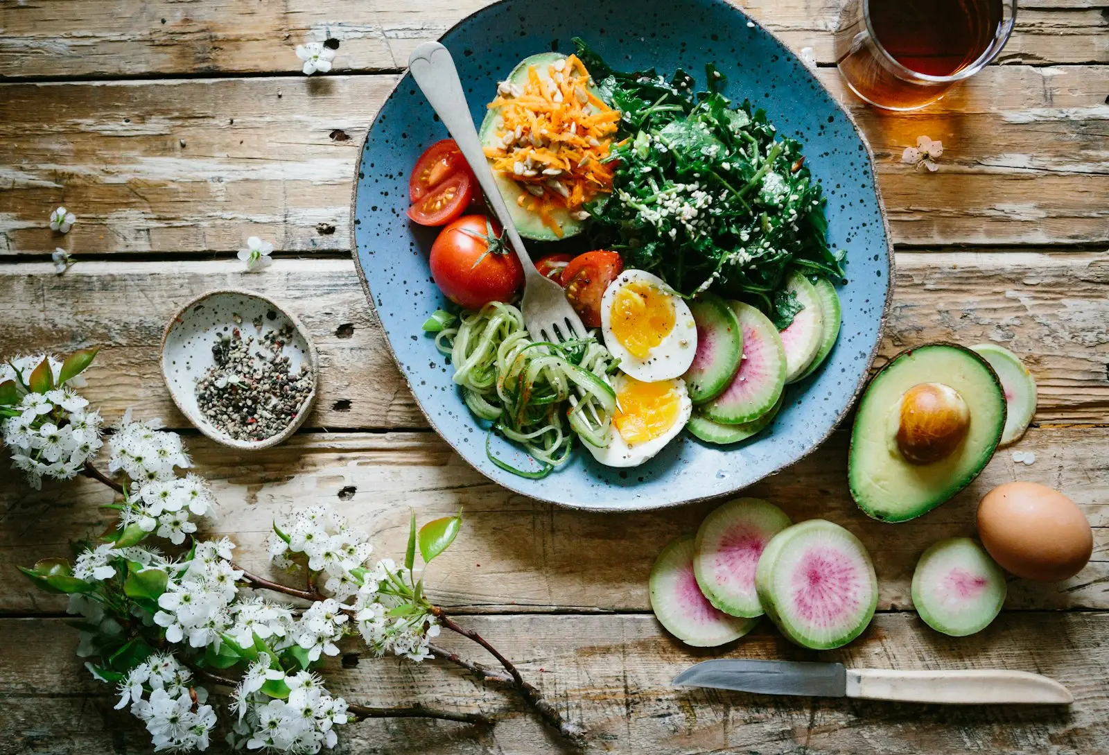 A colourful whole-food plate with greens, eggs and vegetables